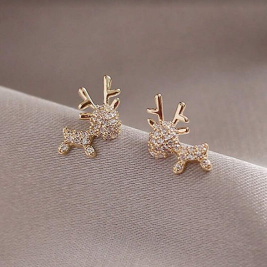 Zircon Deer Earrings on a soft fabric background