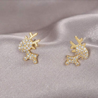 Zircon Deer Earrings with rhinestones on a gray fabric background.