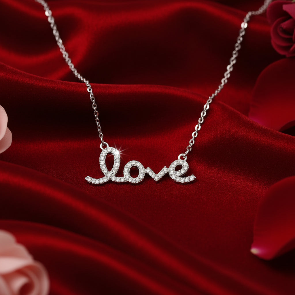 Love Script Rhinestone Necklace on a red fabric background
