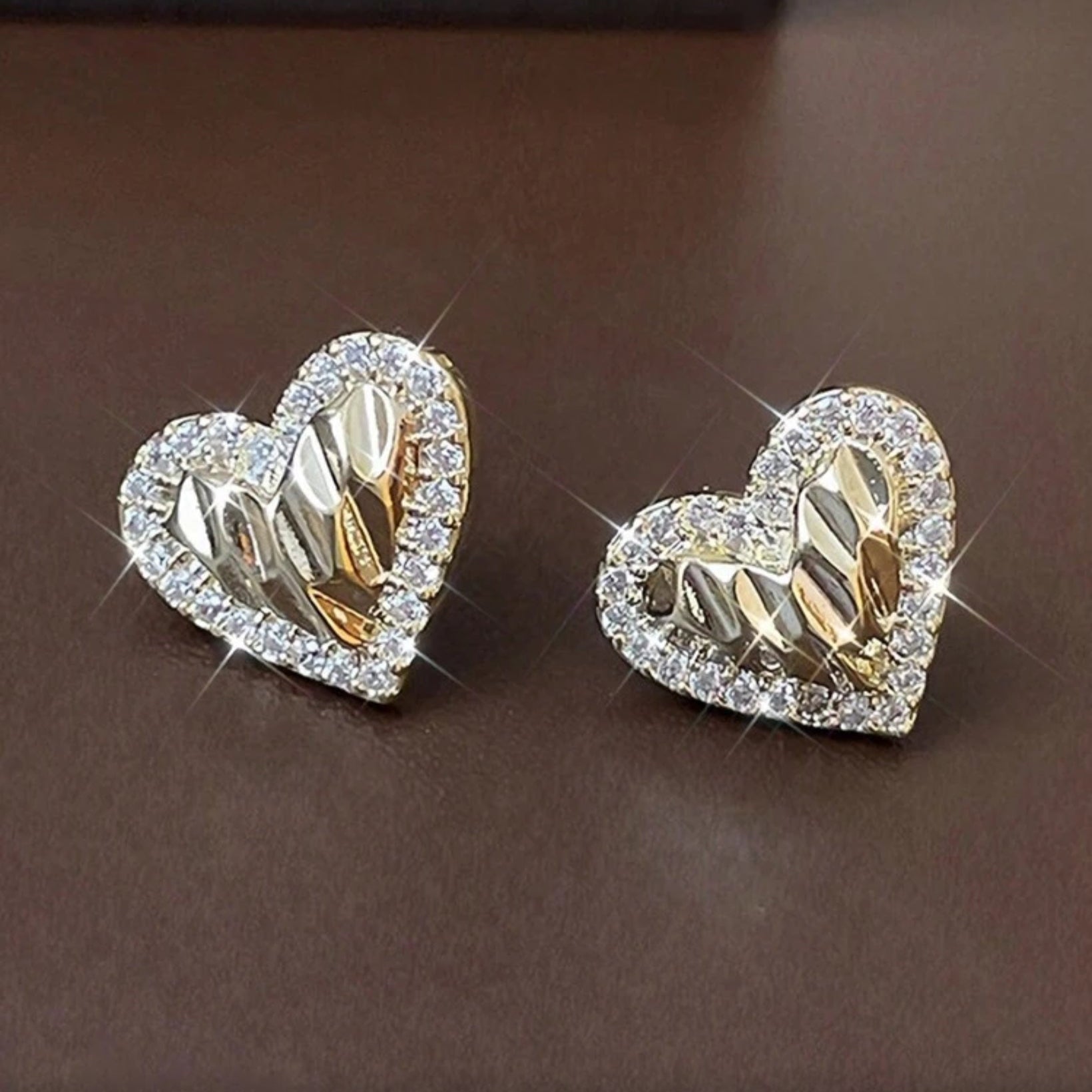 Gold Shimmer Heart Earrings on a brown background