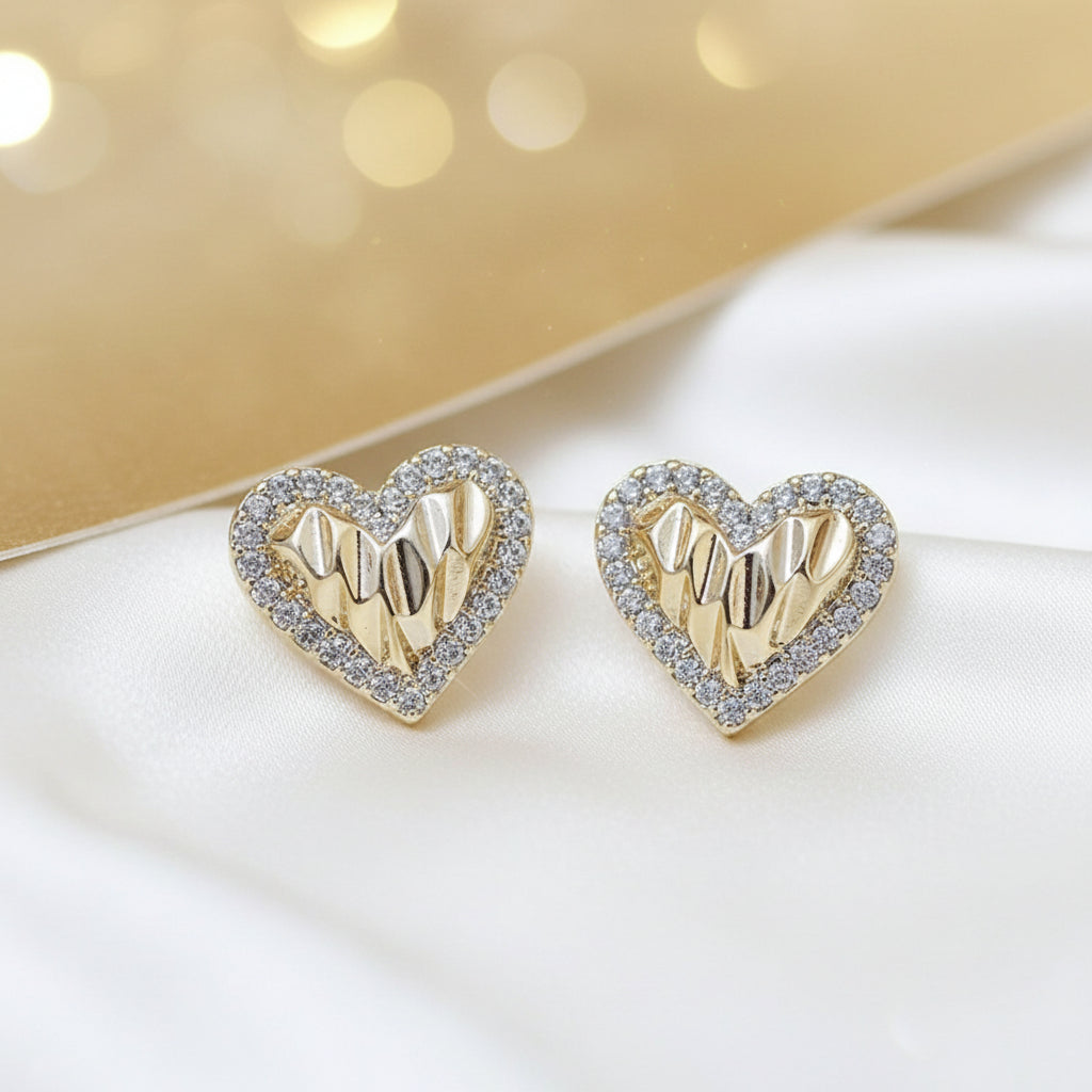 Gold Shimmer Heart Earrings with gold and silver design on a brown background