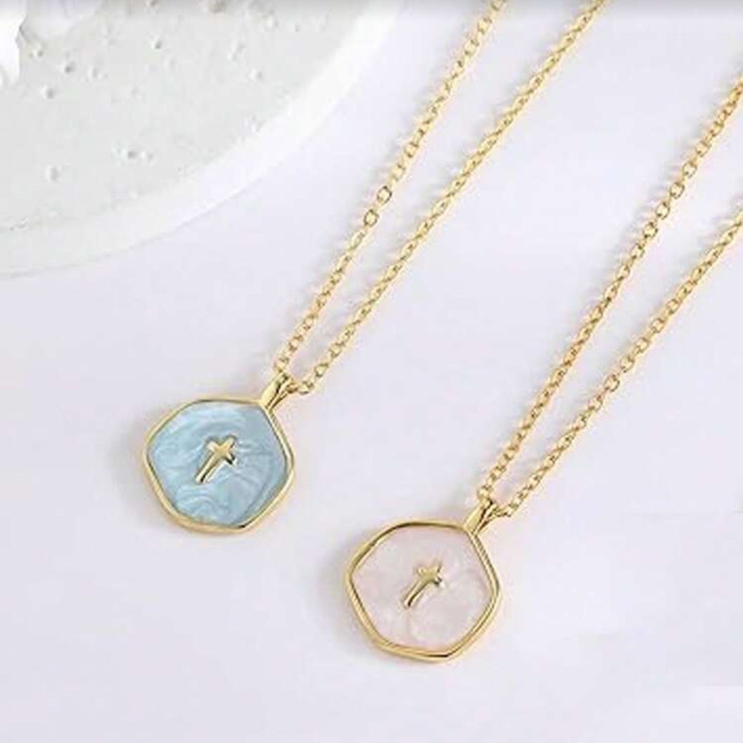 Two Walk in Faith Enamel Cross Necklaces with gemstone pendants on a light background