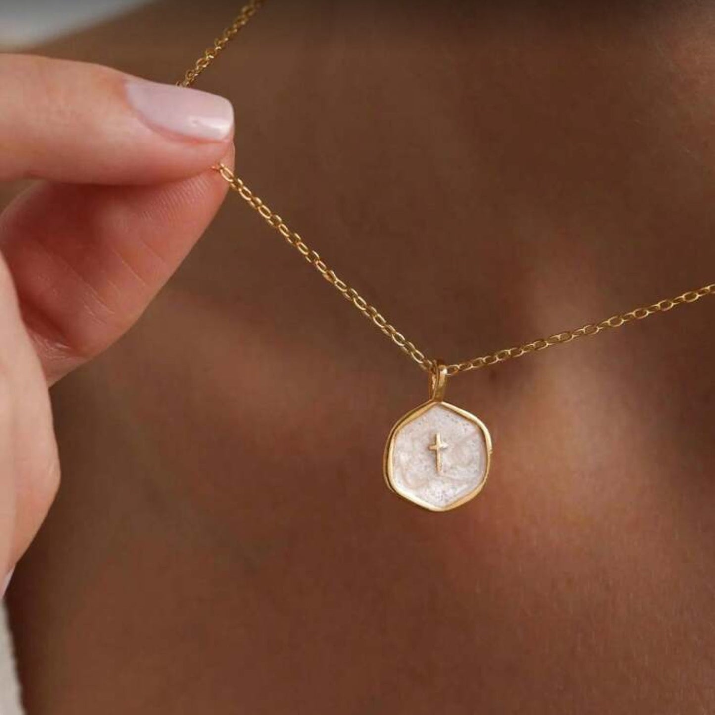 Walk in Faith Enamel Cross Necklace with a circular pendant featuring a cross on a blurred background