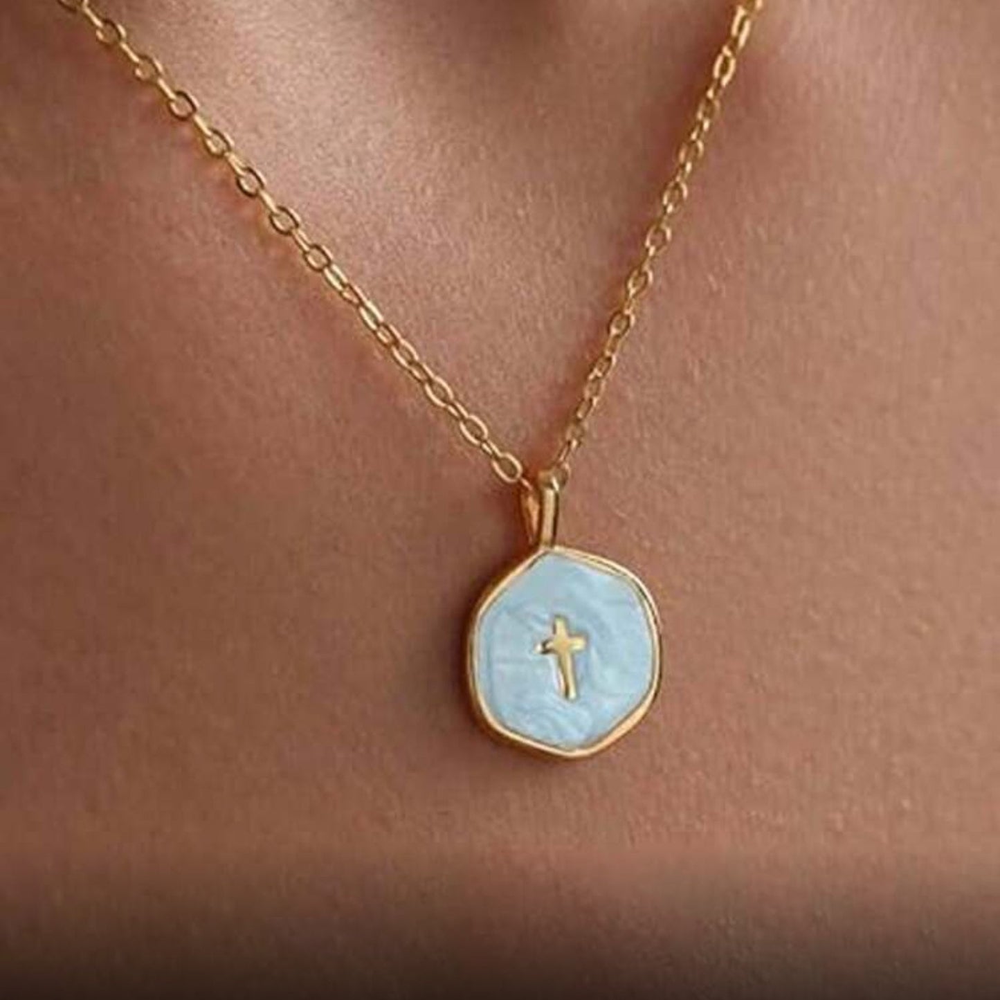 Walk in Faith Enamel Cross Necklace with a light blue pendant featuring a cross on a person's neck.