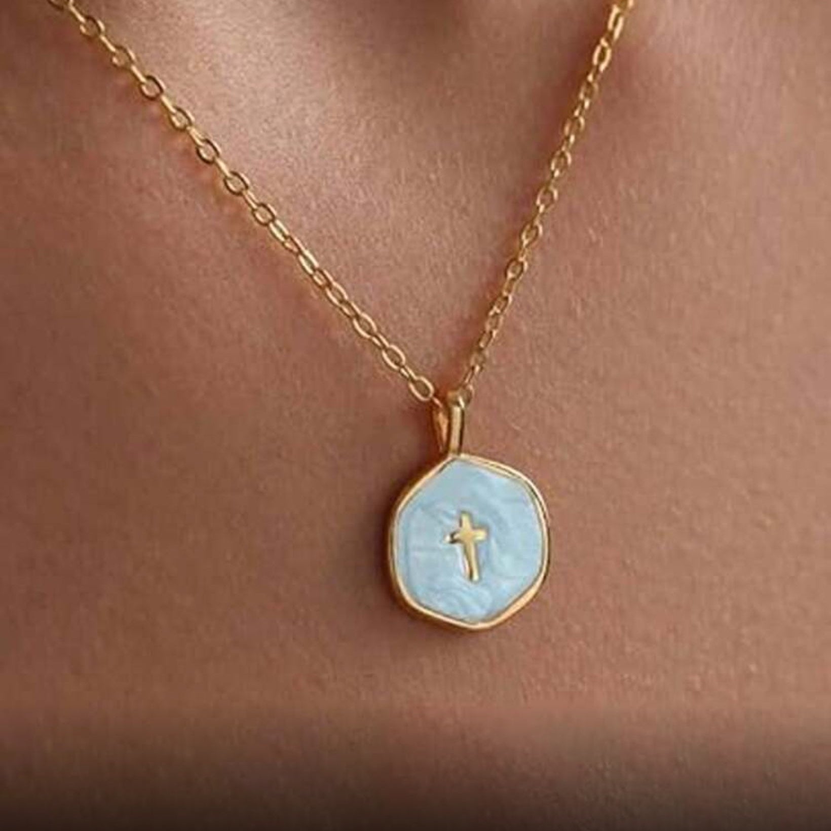 Walk in Faith Enamel Cross Necklace with a light blue pendant featuring a cross on a person's neck.