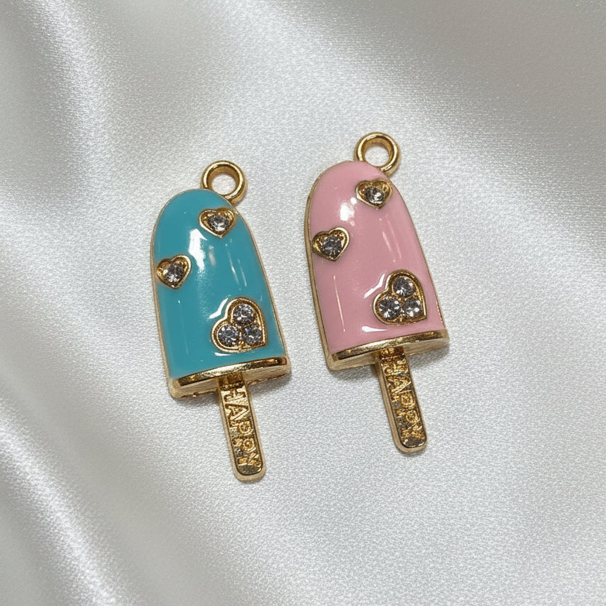 Cotton Candy Popsicle Duo (Pink & Light Blue) charms, one blue and one pink, on a light gray background.