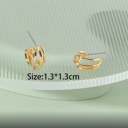 Triple Band Gold Hoop Earrings on a green textured surface with size label.