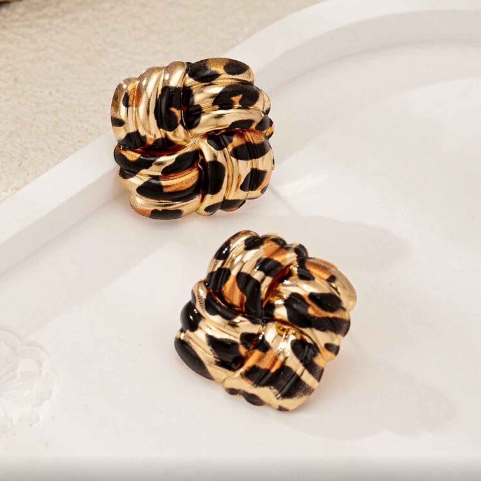 Leopard Square Knot Earrings on a light background