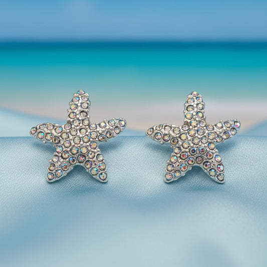 Iridescent Starfish Sparkle Earrings with rhinestones in a beach setting