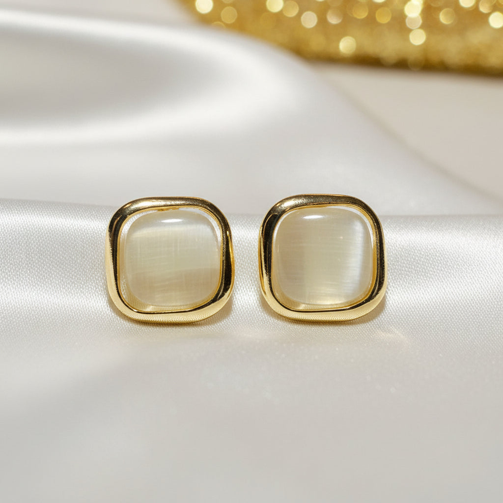 Pearl Square Stud Earrings on light fabric