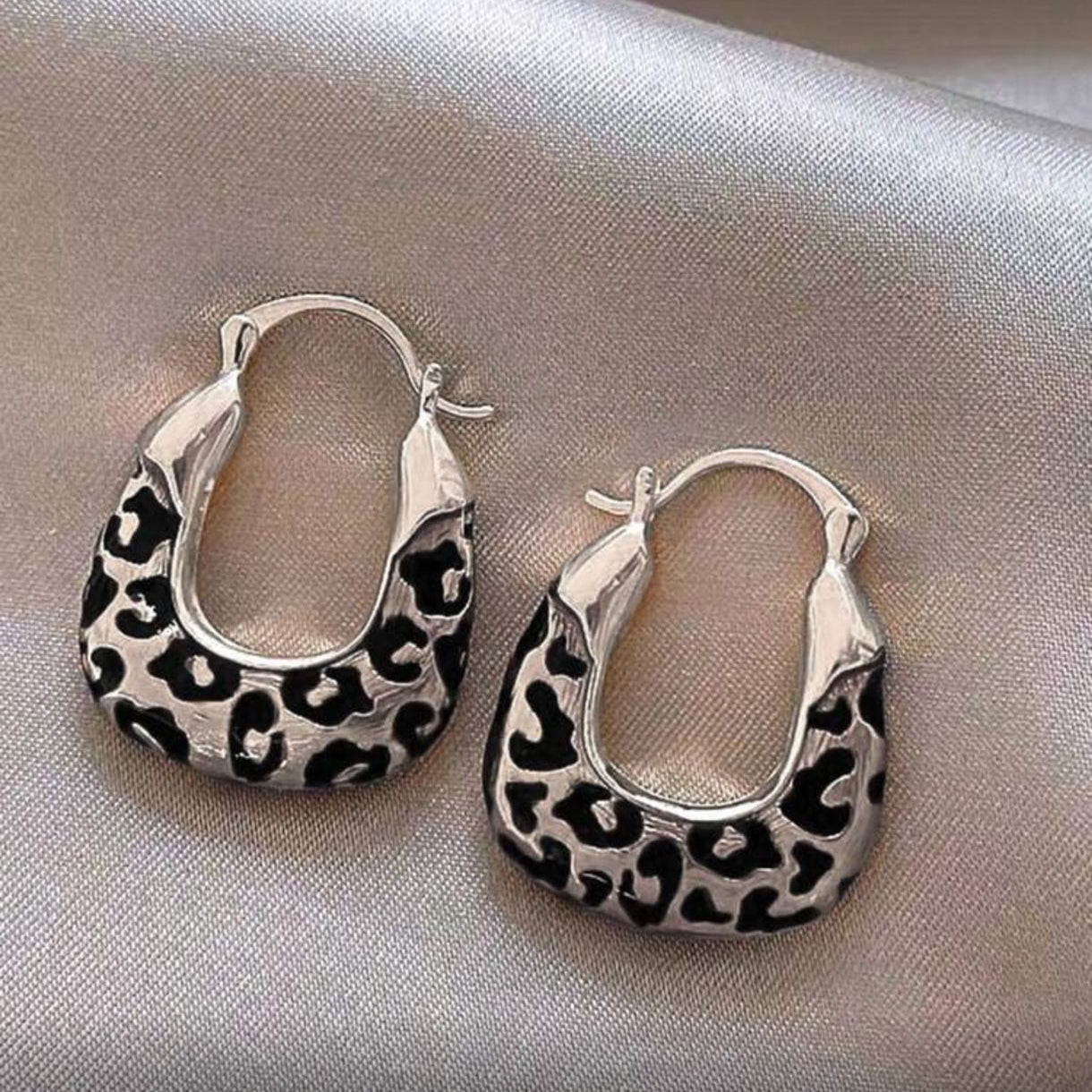 Silver Leopard Hoop Earrings on a light gray background
