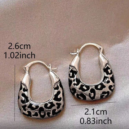 Silver Leopard Hoop Earrings on a gray background