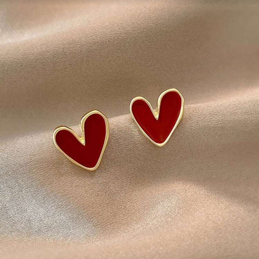 Red Heart Earrings on a beige fabric background