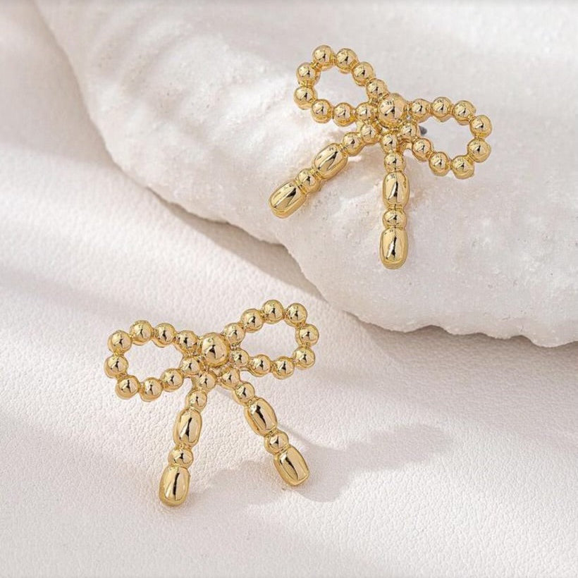 Gold Beaded Bow Earrings on a soft white background