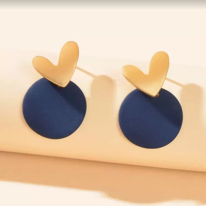 Midnight Blue & Gold Heart Earrings on a beige stand.