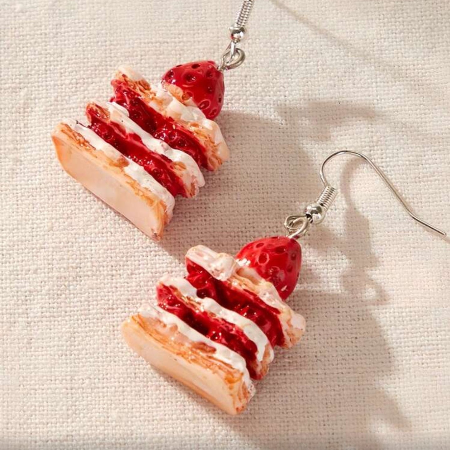 Strawberry Shortcake Layer Earrings on a light fabric background