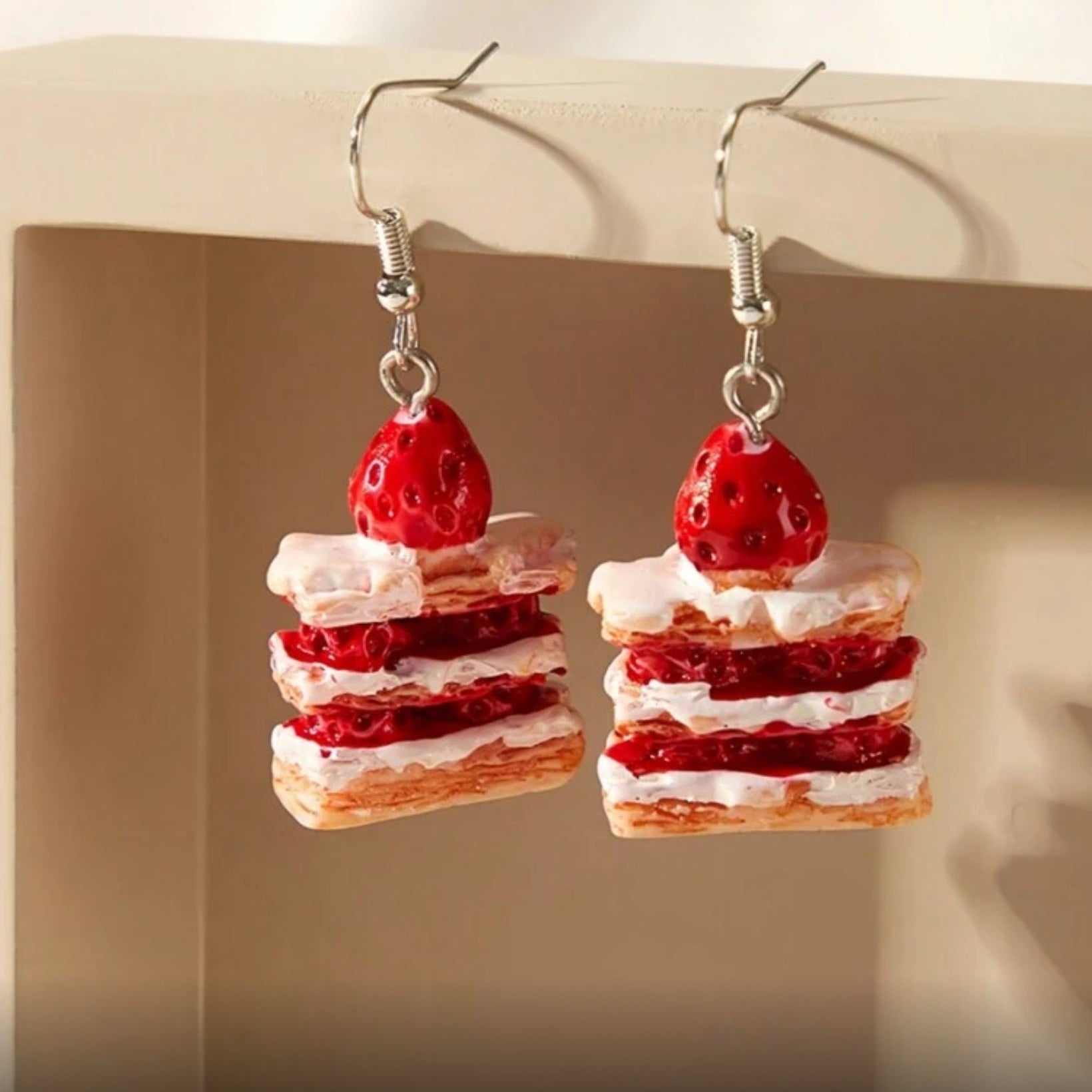 Strawberry Shortcake Layer Earrings with red and white layers on a neutral background