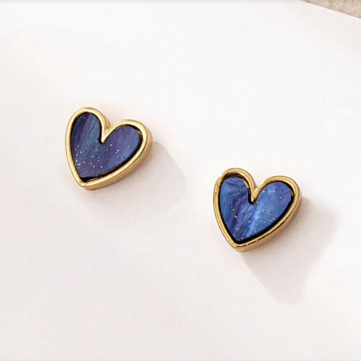 Blue Gold Dust Heart Earrings with blue and gold design on a white background