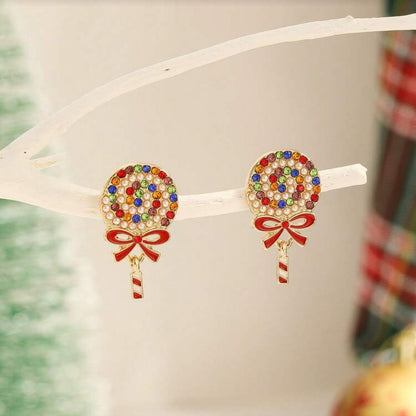 Holiday Sparkle Lollipop Earrings on a white surface with a blurred background