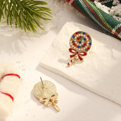Holiday Sparkle Lollipop Earrings on a snowy surface with Christmas-themed elements.