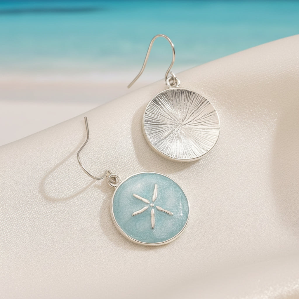 Seafoam Sand Dollar Earrings with textured circular designs on a beige background
