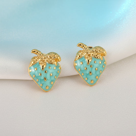 Light Blue Strawberry Earrings with gold accents on a beige surface