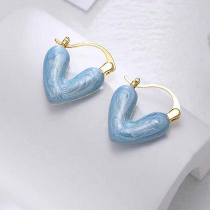 Blue Stone Heart Earrings with gold accents on a white background