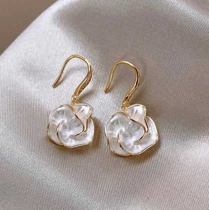 Golden Edge Pearl Drop Earrings on a light fabric background