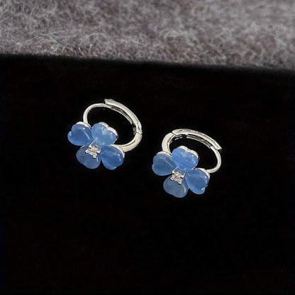 Blue Flower Petal Hoop Earrings on a dark background