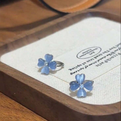 Blue Flower Petal Hoop Earrings on a wooden tray with a white card.