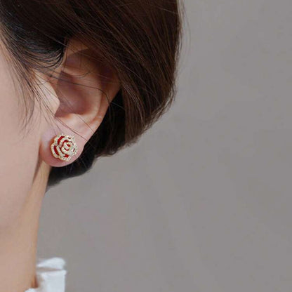 Close-up of an ear wearing a Rhinestone Rose Earring with a blurred background