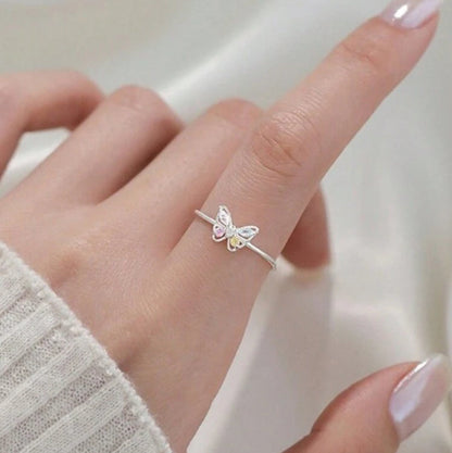 Pastel Butterfly Adjustable Ring on a finger with a neutral background