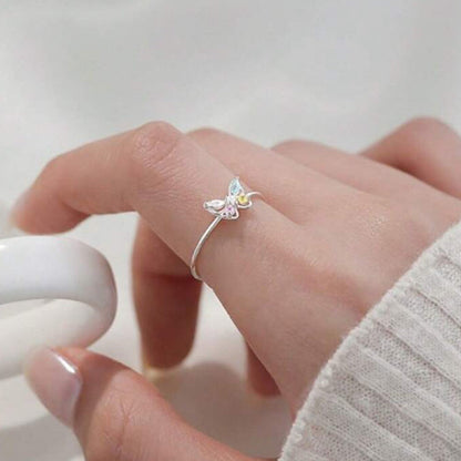 Pastel Butterfly Adjustable Ring on a finger against a neutral background