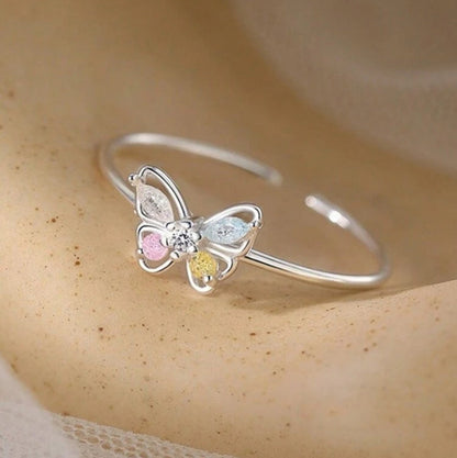 Pastel Butterfly Adjustable Ring with a neutral background
