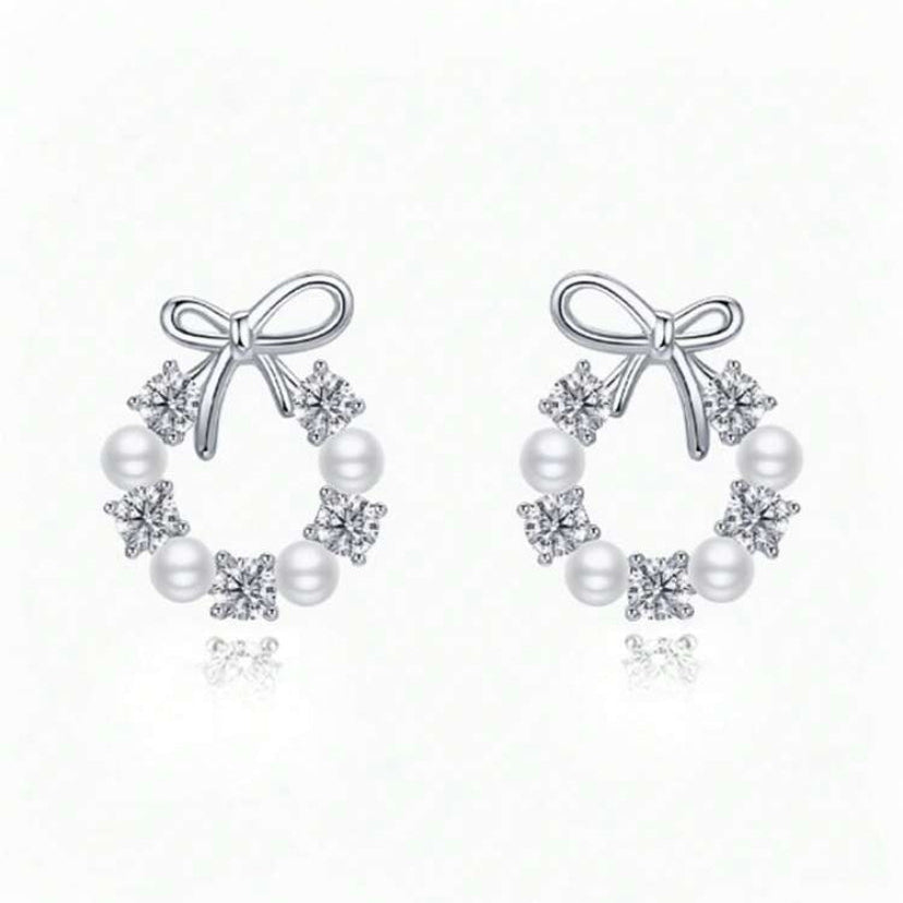 Pair of Silver Bow Wreath Earrings with bow and pearl design on a white background