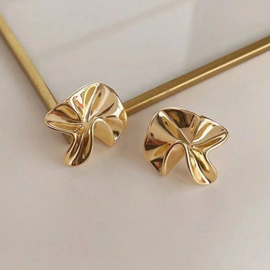 Gold Sculpted Petal Earrings on a light background