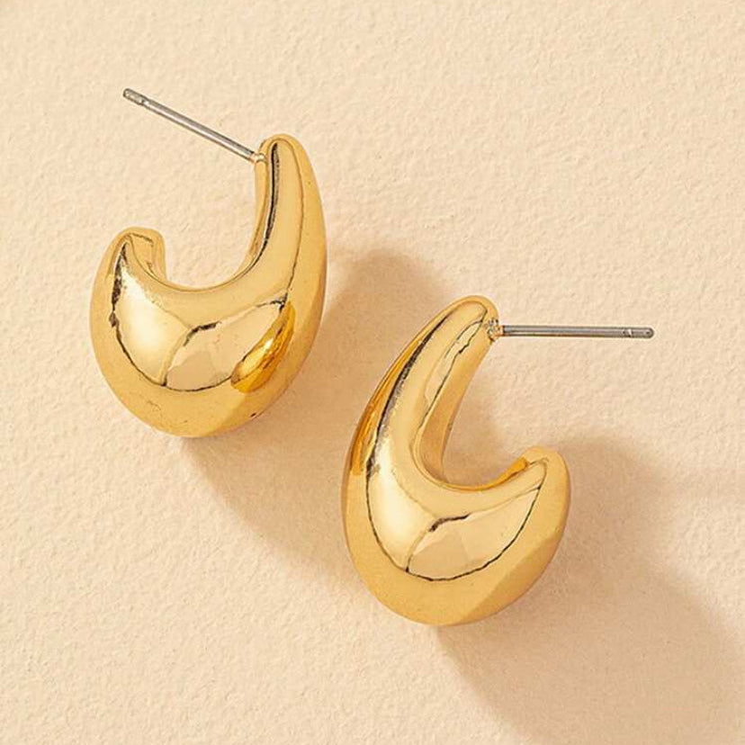 Gold Teardrop Hoop Earrings on a beige background
