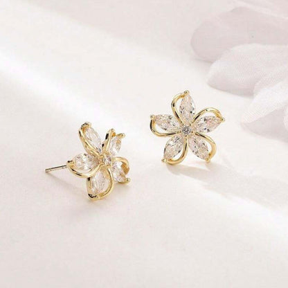 Gold Crystal Flower Earrings with clear gemstones on a light background