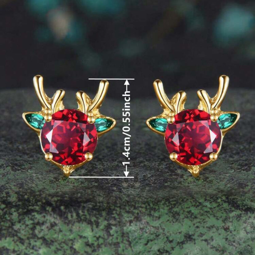 Holiday Red & Green Reindeer Earrings with red gemstones on a dark green surface and dimensions