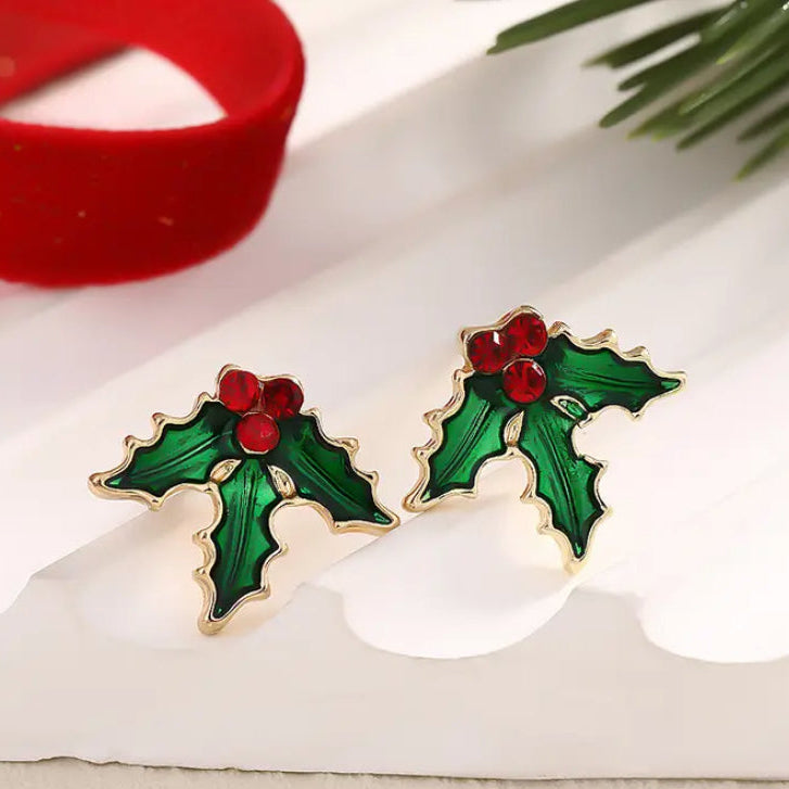 Red Berry Holly Earrings with red centers on a white surface.