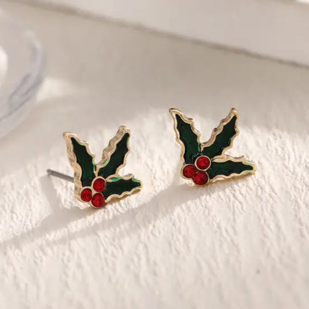 Red Berry Holly Earrings with red berries on a white surface
