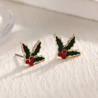 Red Berry Holly Earrings with red berries on a white surface