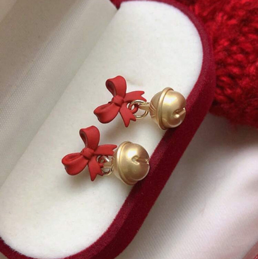 Jingle Bell Bow Earrings on a red and white jewelry box.