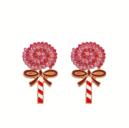 Oversized Holiday Candy Swirl Lollipop-shaped earrings with pink gemstones and red and white striped sticks on a white background