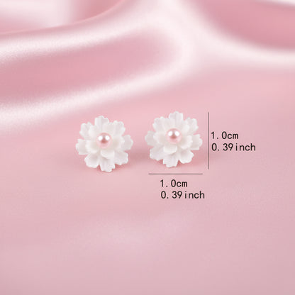 Flower-shaped earrings with measurements on a white background