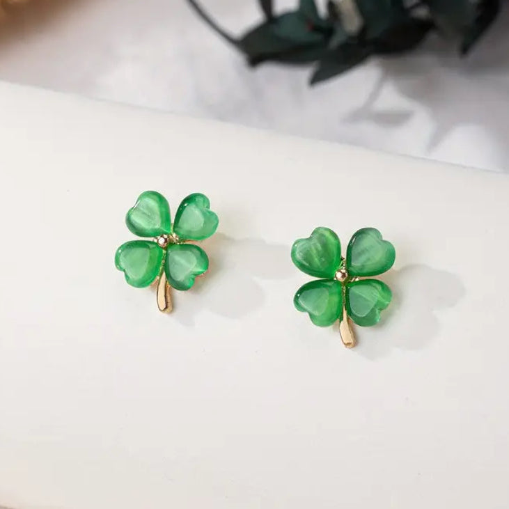 Gold and Green Four-Leaf Clover Shamrock Earrings on a white surface