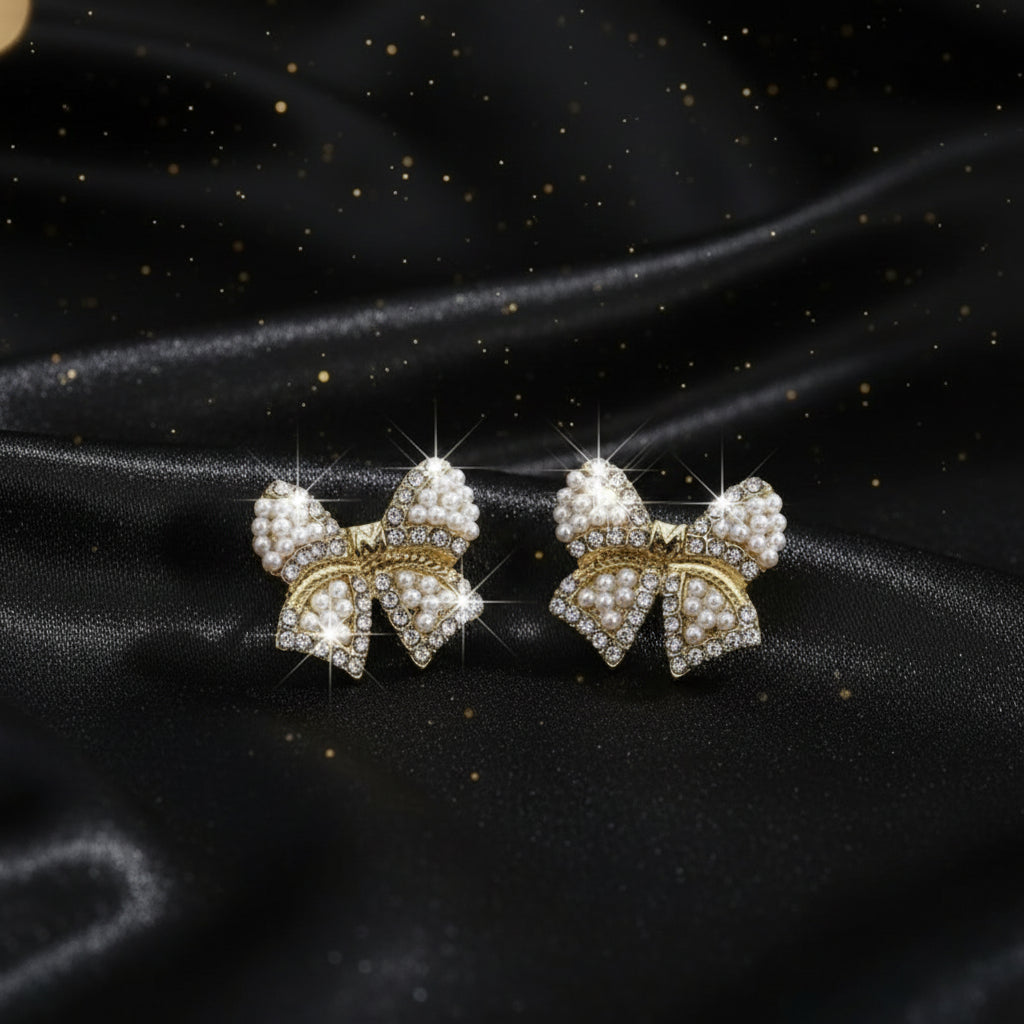 Classic Pearl Bow & CZ Earrings with pearl details on a brown surface