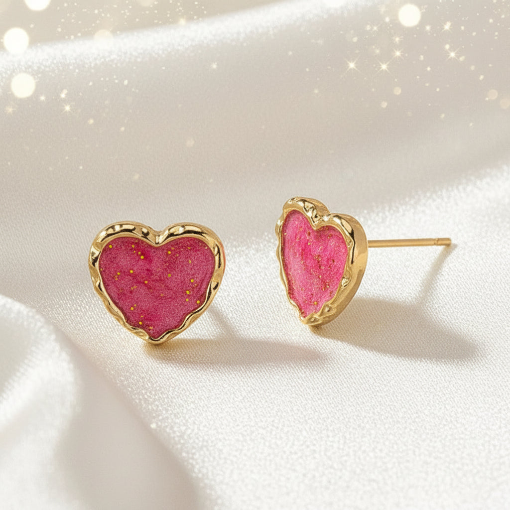 Pink Gold Dust Heart Earrings with pink center and gold border on beige background