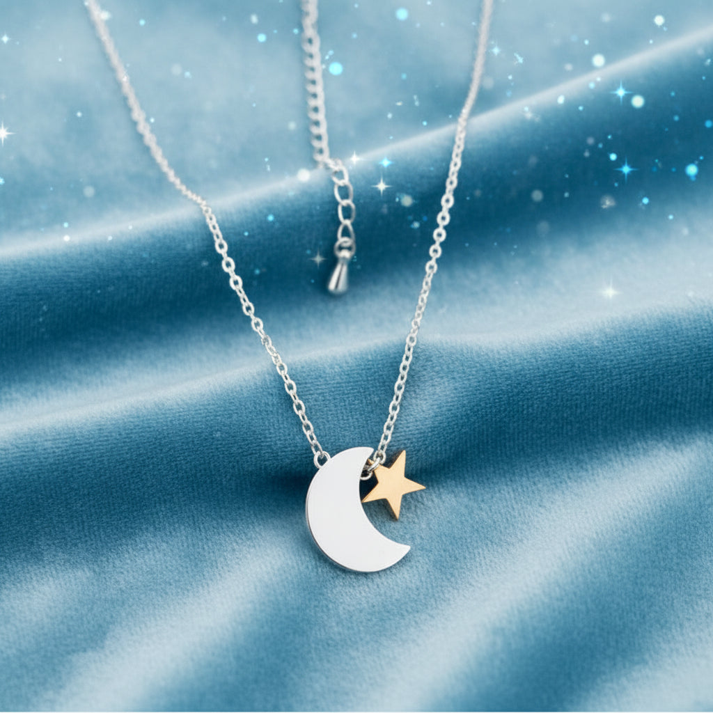 Silver & Gold Crescent Moon Star Necklace on a dark fabric background