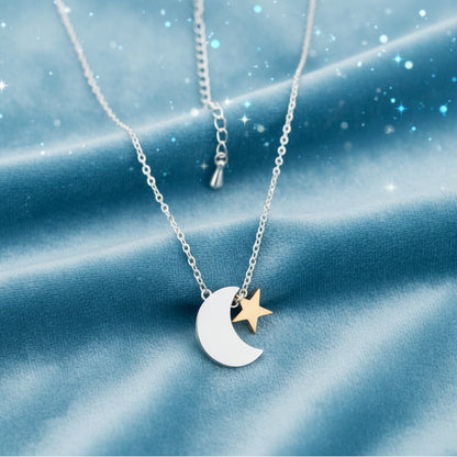 Silver & Gold Crescent Moon Star Necklace on a dark fabric background